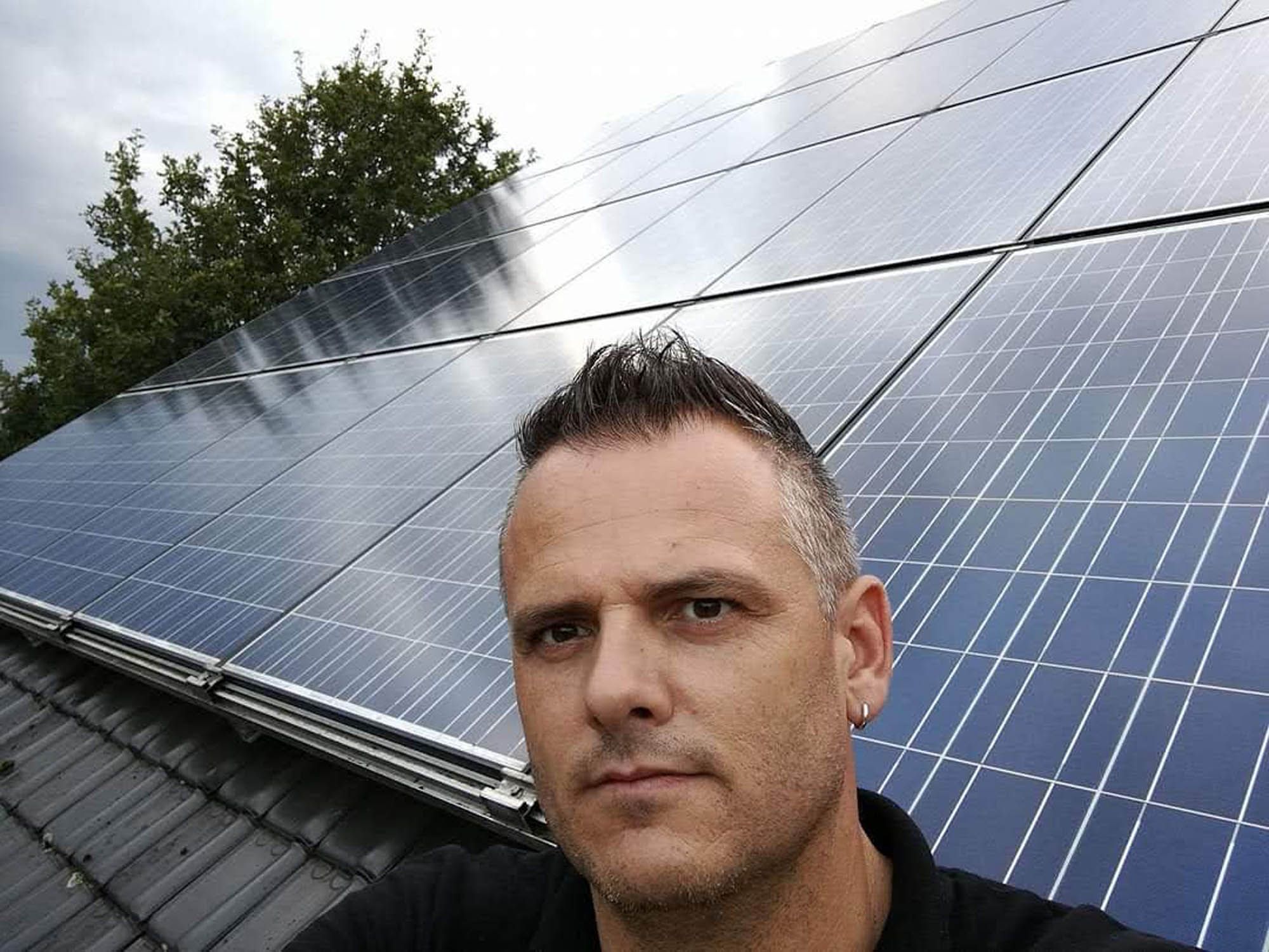 Benny Verelst bij een pas gereinigde installatie zonnepanelen
